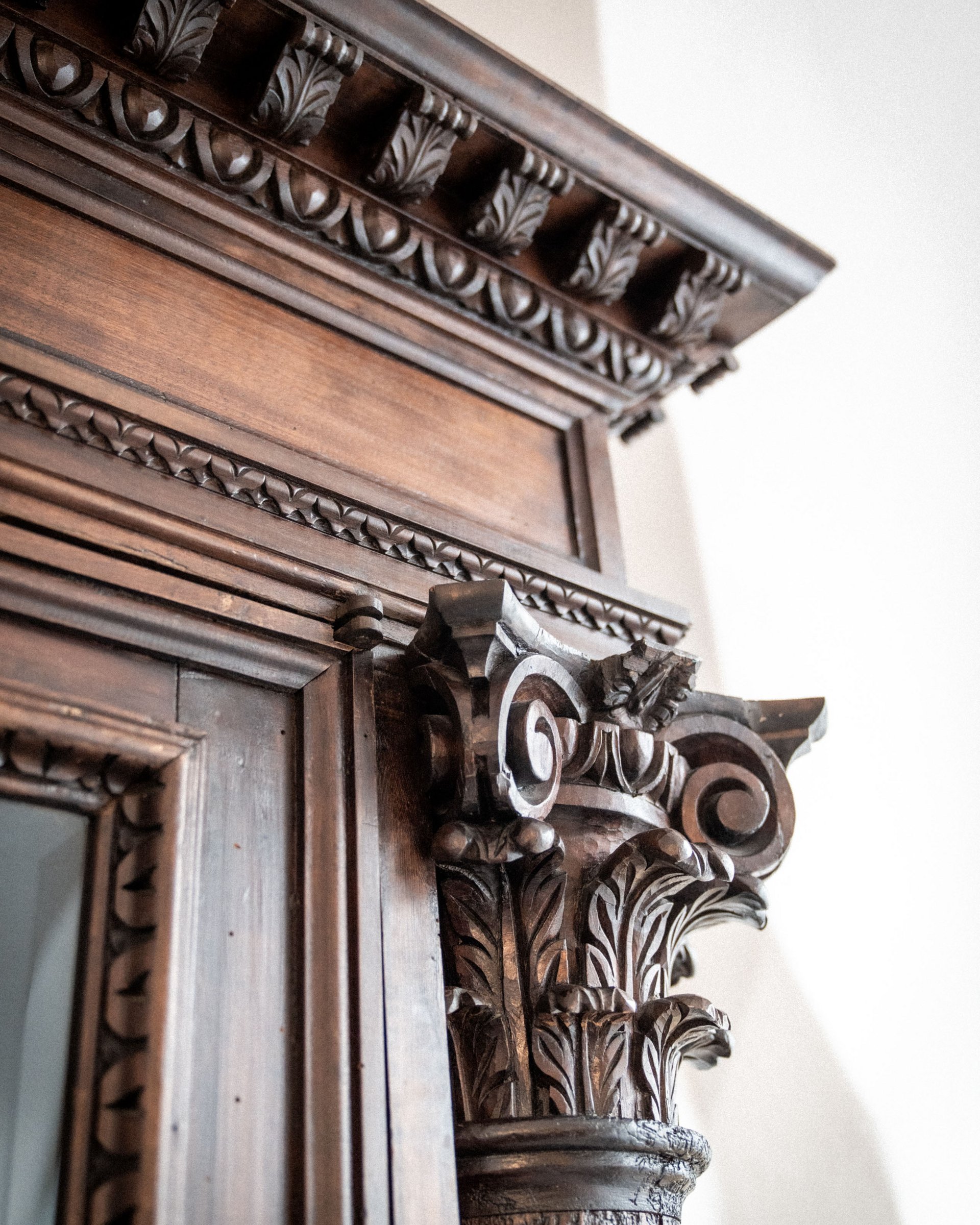 Carved ornate wooden detail of an antique door or column