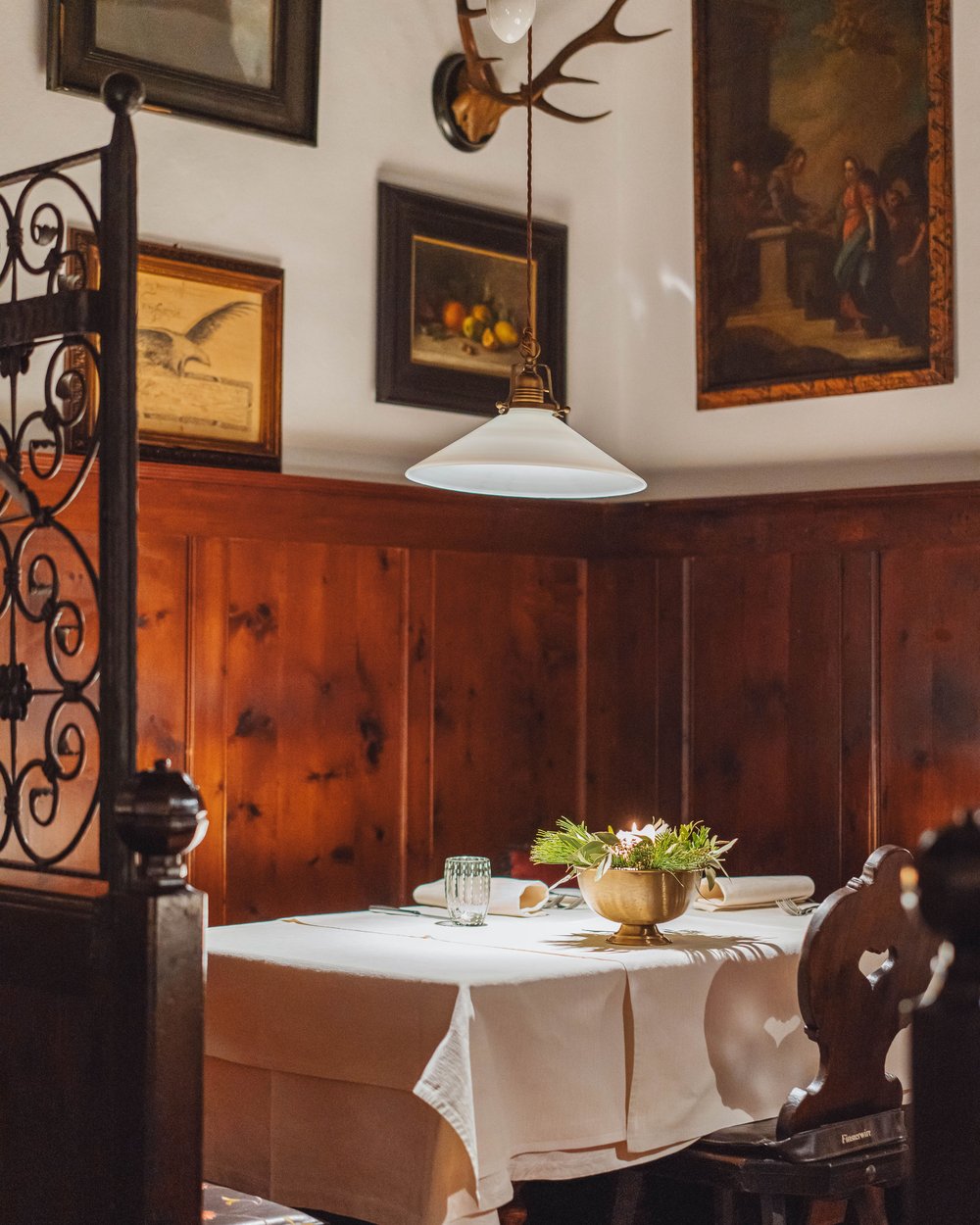 Cozy corner with white set table and wooden paneling