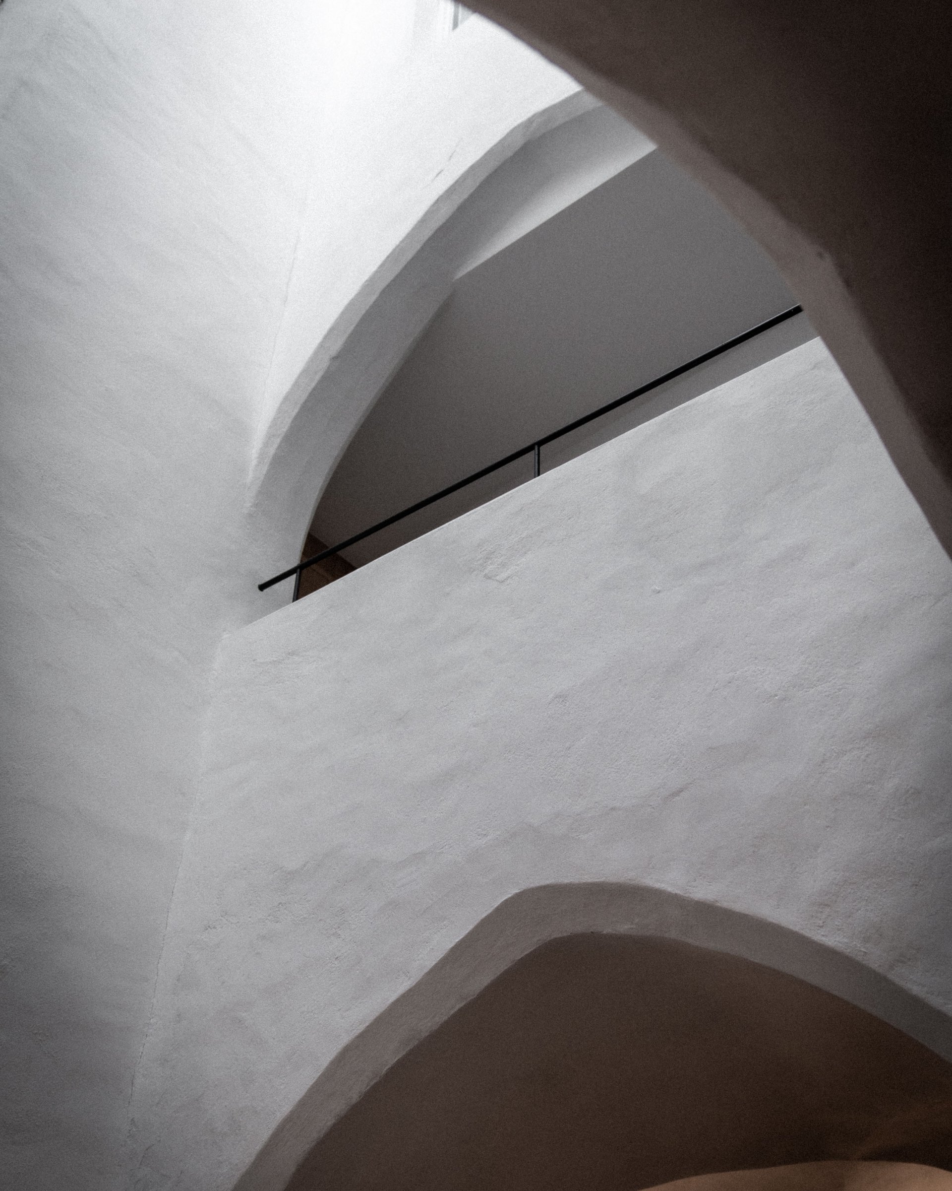 Interior view of white arched ceilings and walls with minimalist design