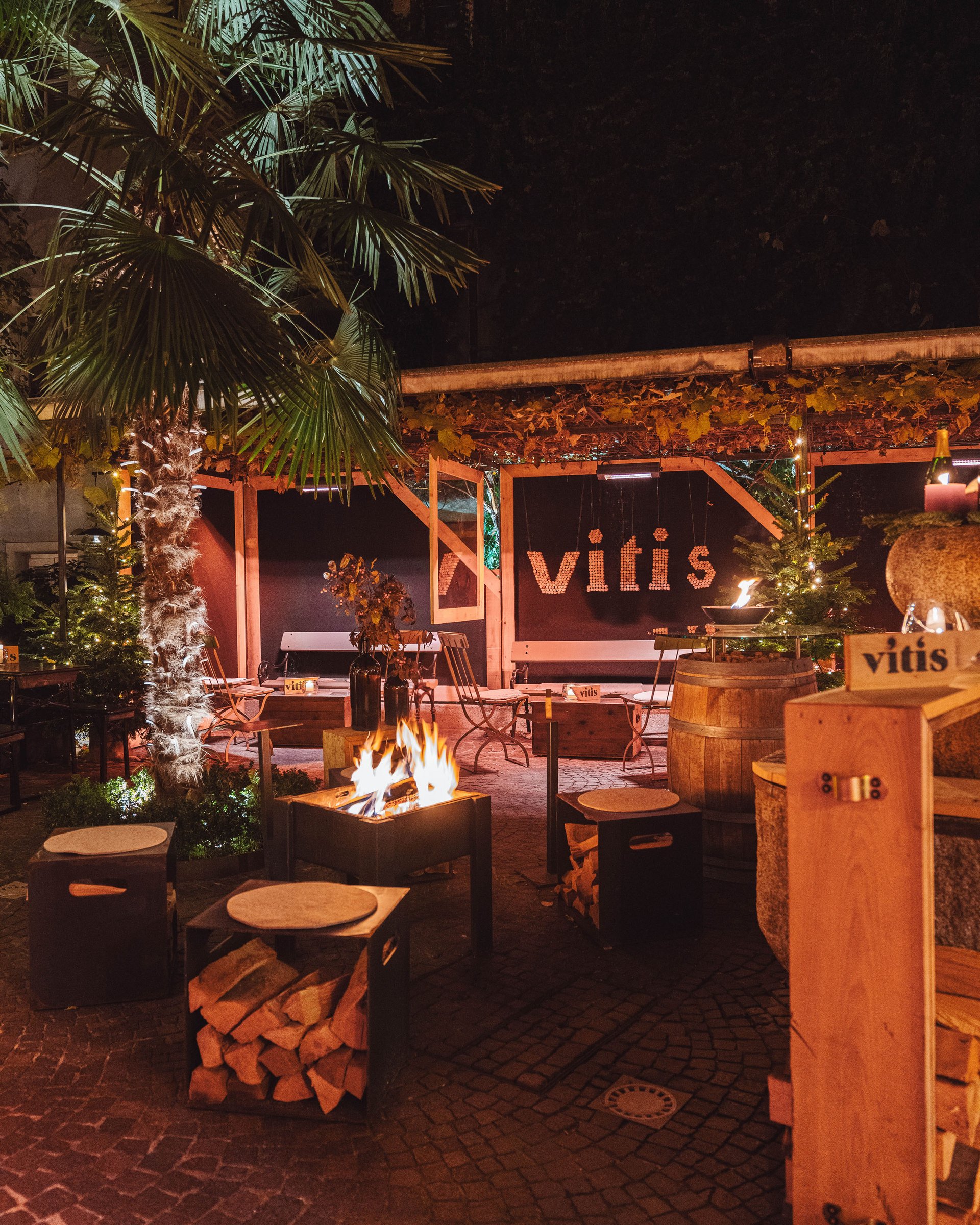 Cozy outdoor area with fire pit and seating at night