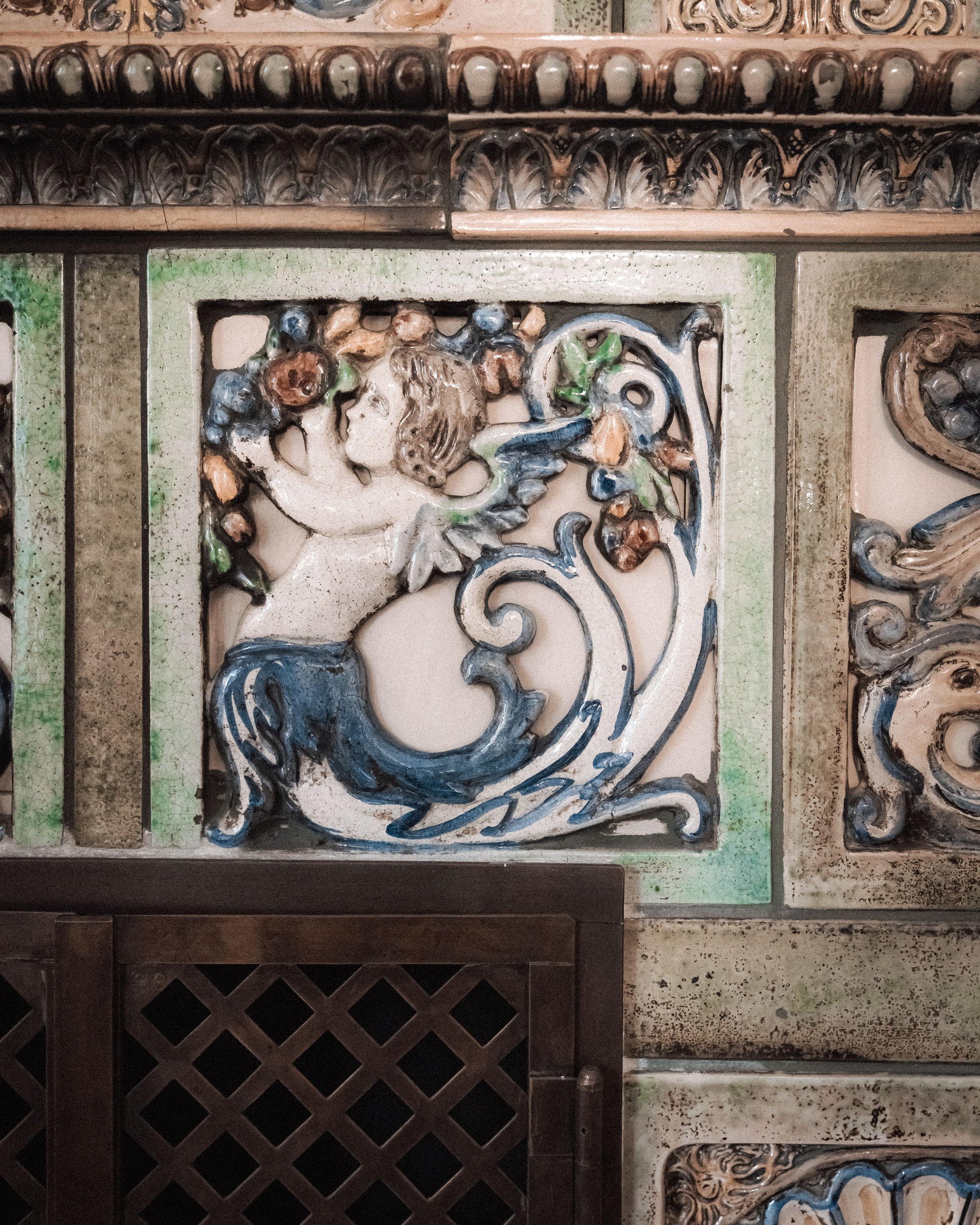 Ceramic tile with ornate angel and floral decoration