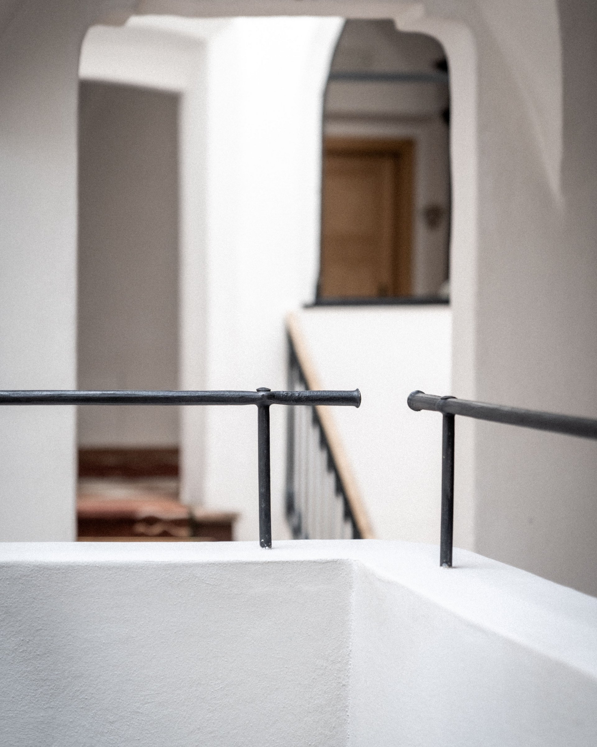Modern interior courtyard with white walls and black railing