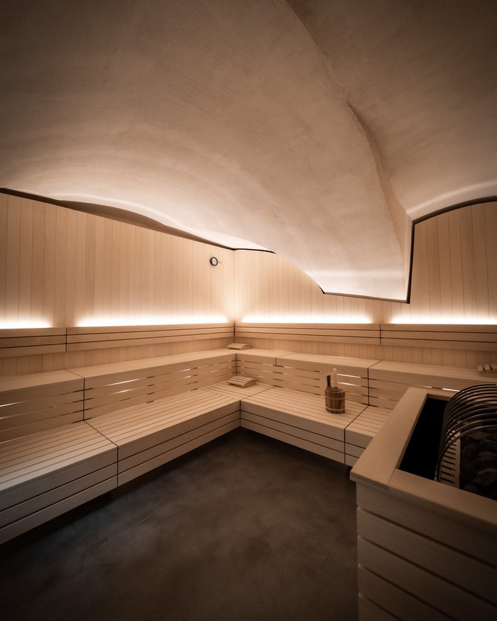 Modern sauna with light wood and indirect lighting