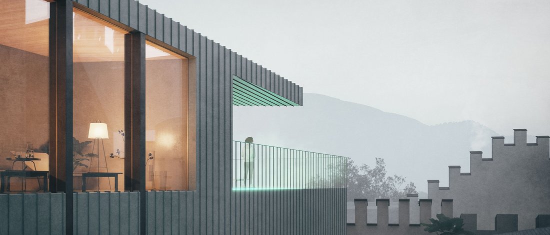 Modern balcony with glass railing and lit terrace at dusk