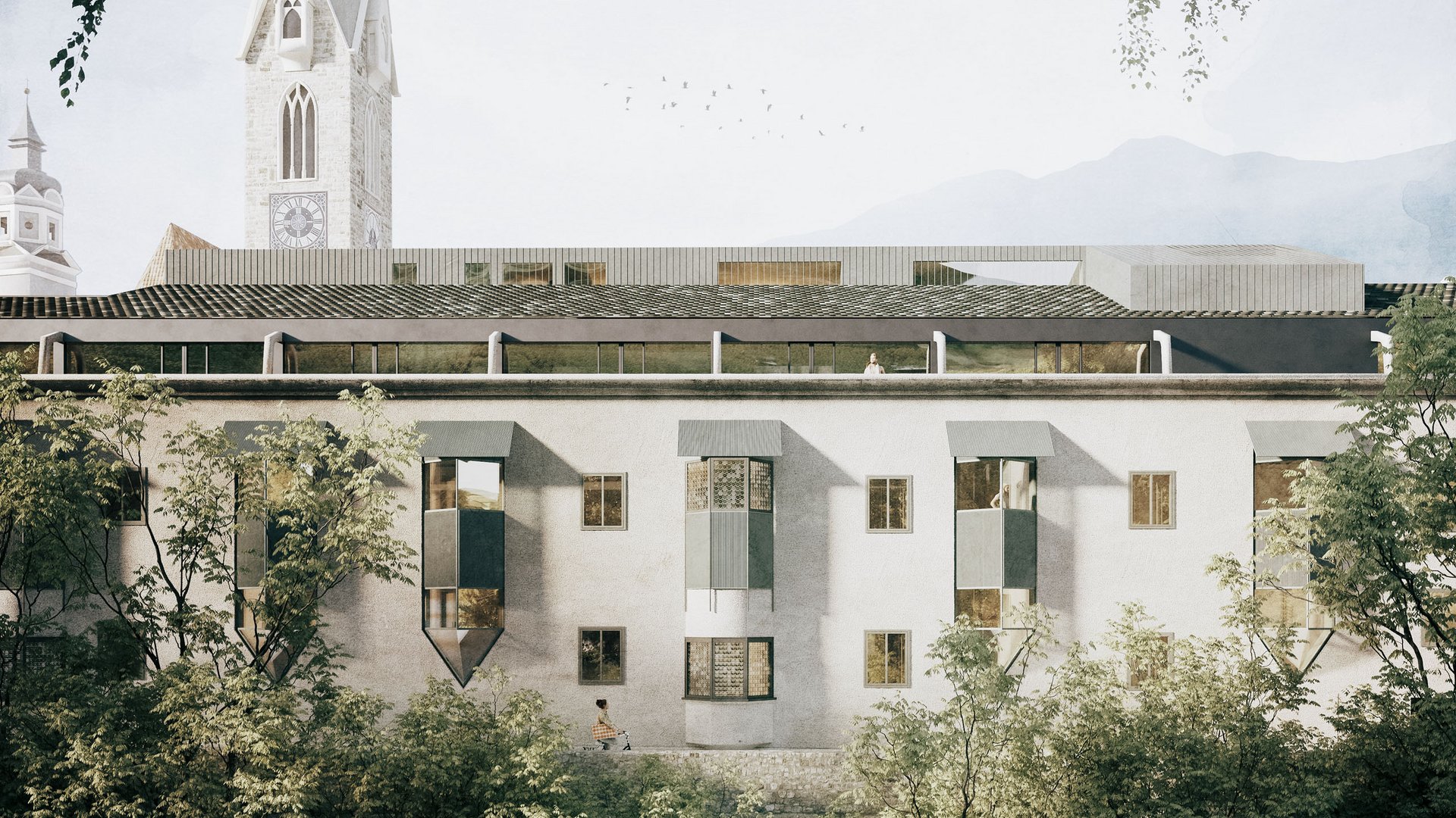 Altes Gebäude mit spitzem Kirchturm und Fluss im Vordergrund