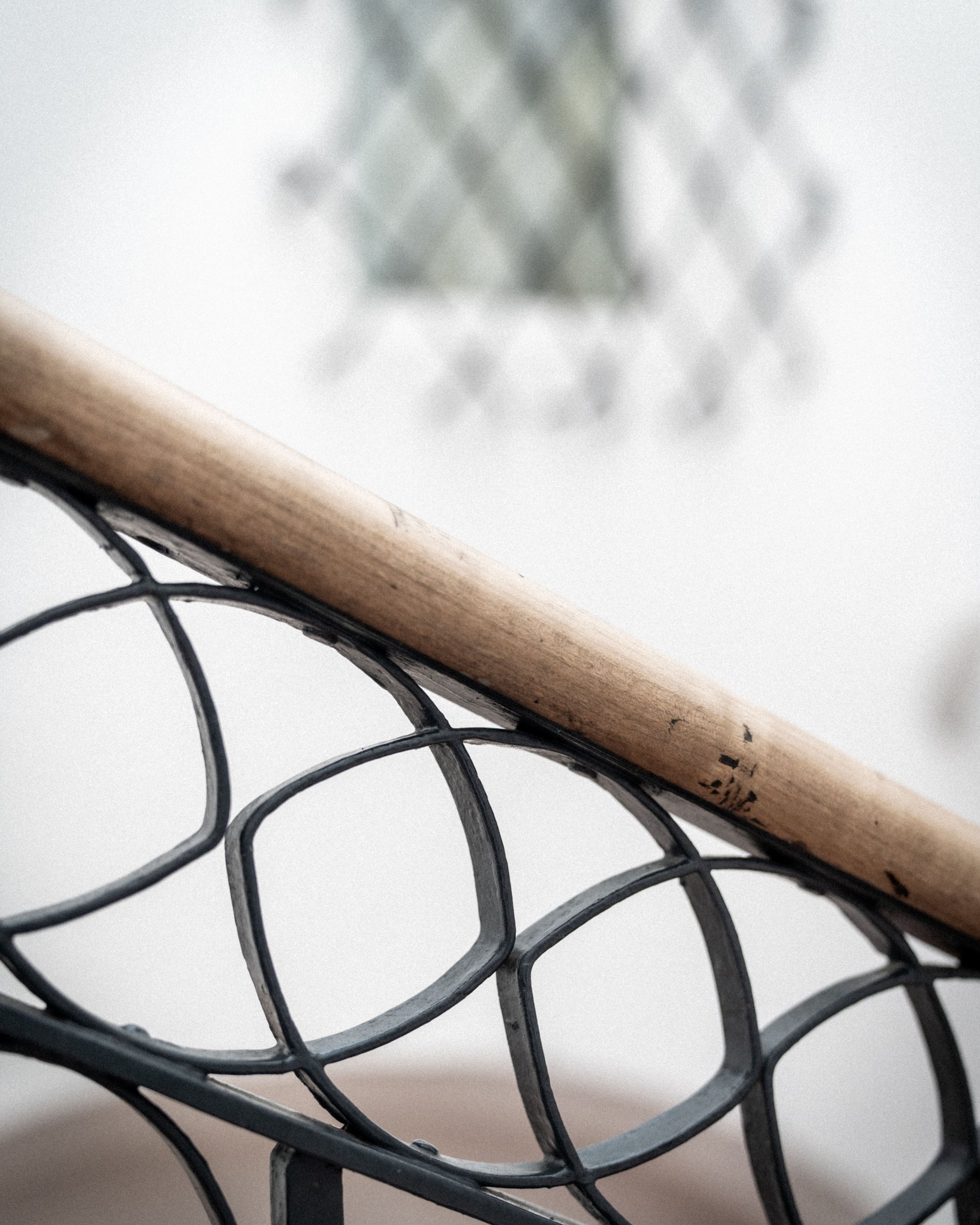 Close-up of a modern staircase railing with wooden handrail and metal frame